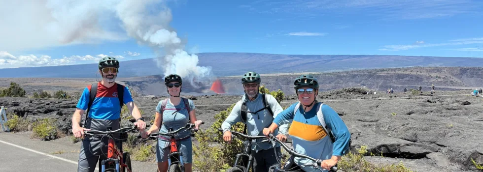 Bike tour guests pose in front of lava eruption