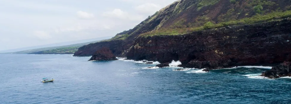 Fast boat near kona cliffs