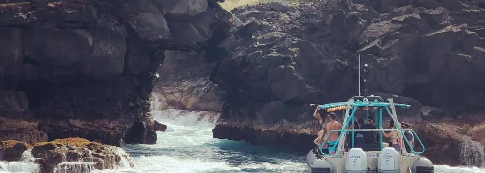 Kona boat approaching cliffs