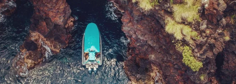 Kona boat entering lava tube