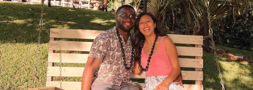Happy luau couple on bench swing
