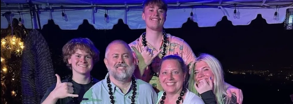 Family portrait with luau staff
