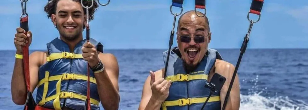 Friends laughing while waikiki parasailing