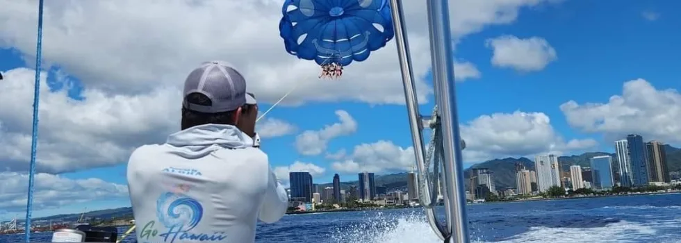 Parasail guide takes photos from boat