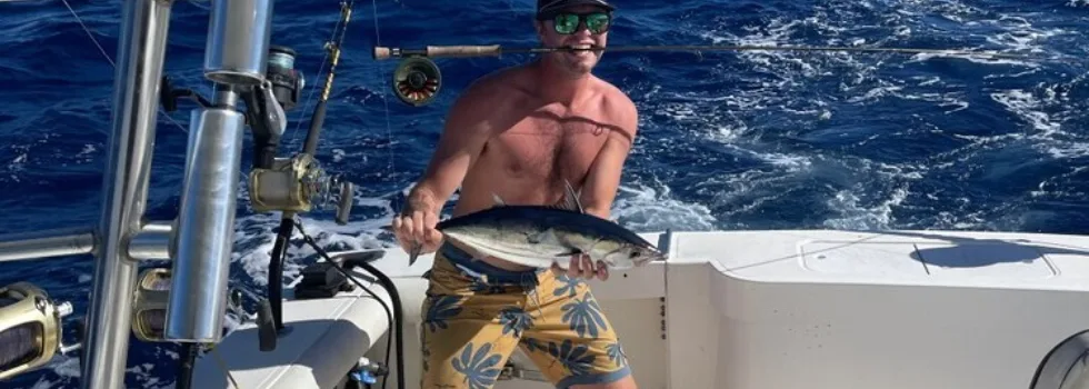 Man poses on honolulu deep sea fishing charter