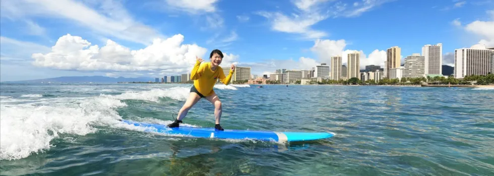 Surf student smiling while riding wave