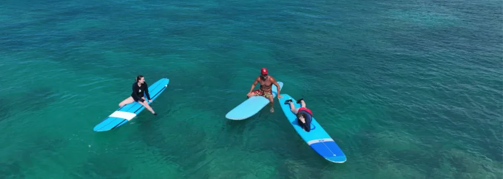 Waikiki surf instructor helps students in ocean
