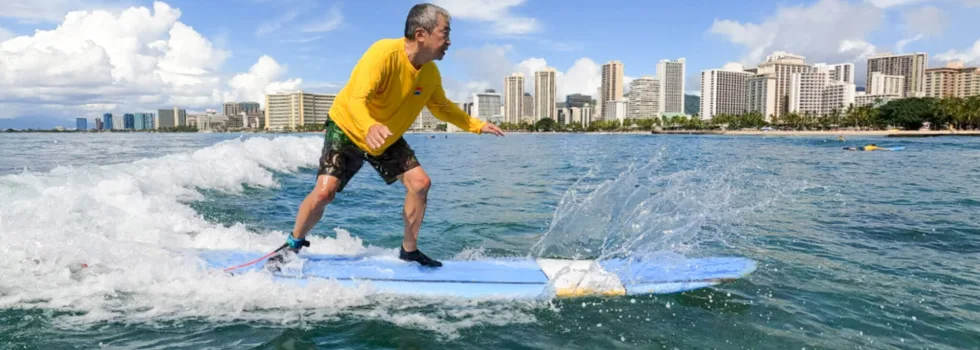 Older man learns to surf in waikiki