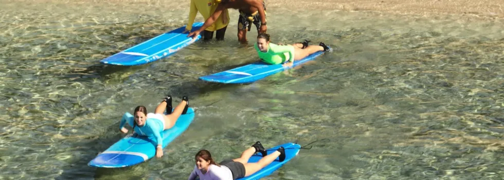 Surf lesson entering ocean in waikiki