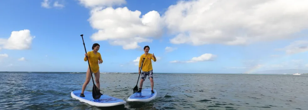Couple stand up paddle boards in waikiki