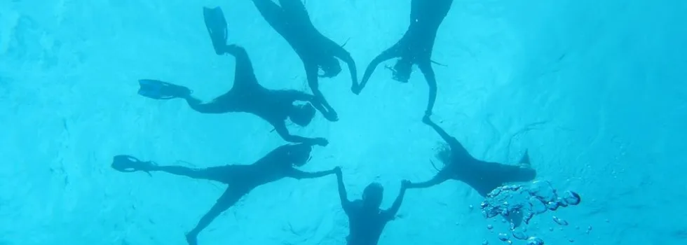 Snorkel group holding hands