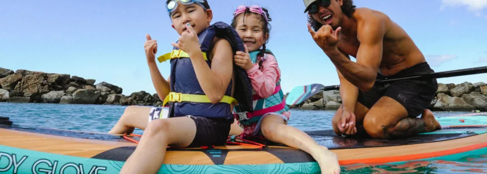 Kids paddle board with boat tour guide