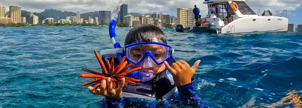 Waikiki kid holding pencil urchin