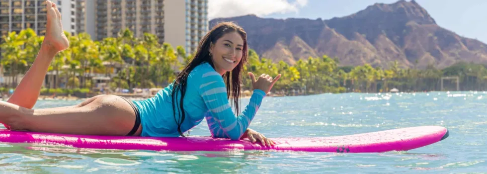 Female surfer laying on board