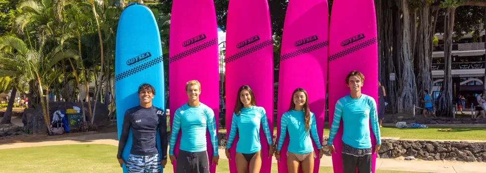 Surf lesson posing with boards on beach jpg