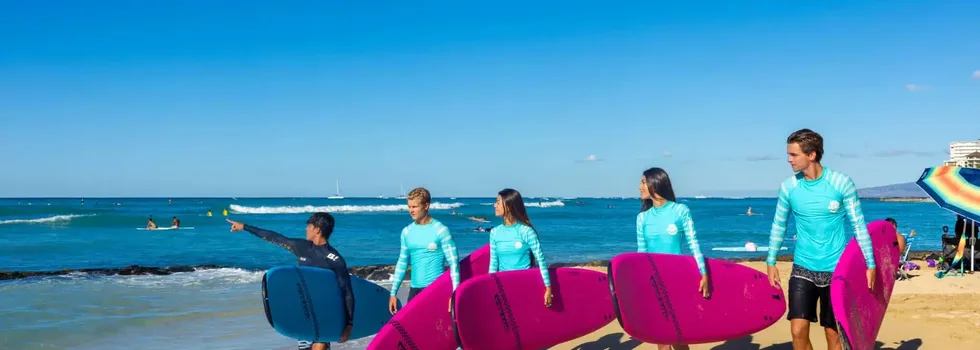 Walking on beach before surf lesson jpg