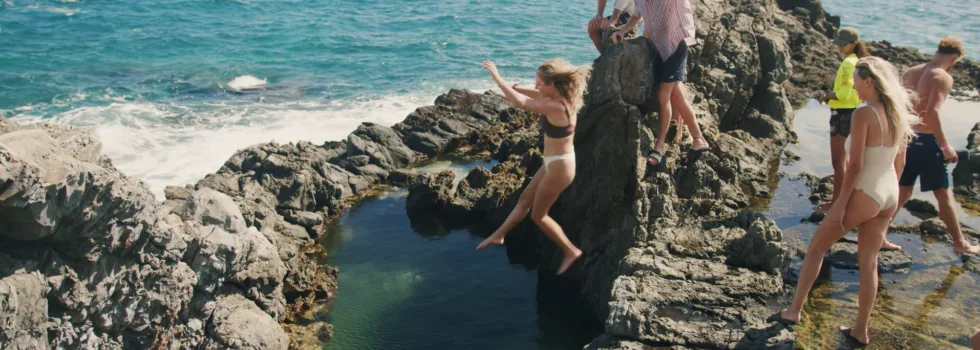 Girl jumping into queens bath tidepool mokulua