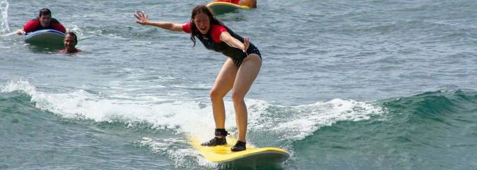 Woman taking surf lesson kauai