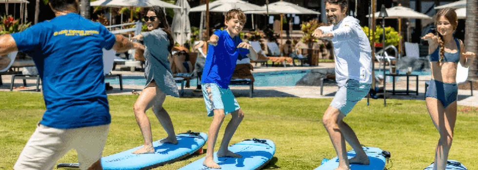 Surf students practice standing on land in poipu