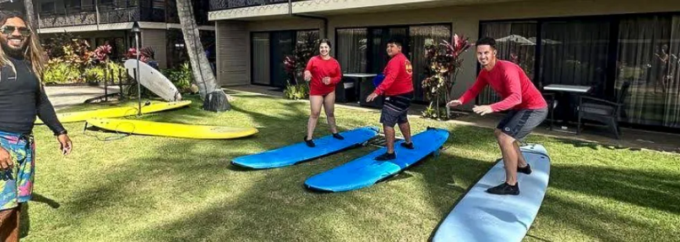 Surf instructor in poipu hotel teaching how to stand up