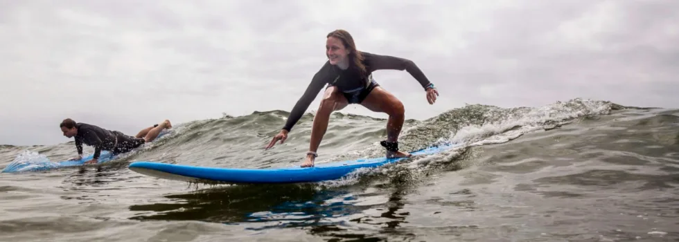 Woman learning to surf in poipu