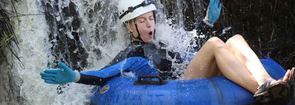 Soaking in waterfall while tubing