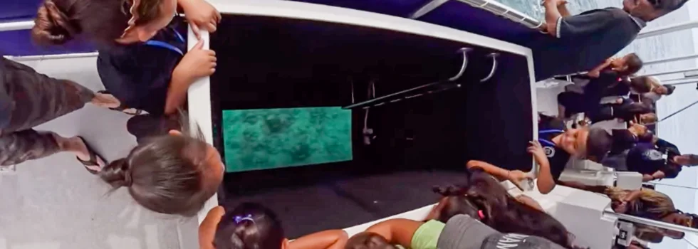 Family gathers around glass bottom boat