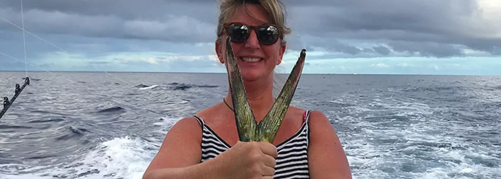 Woman holding mahi mahi kona
