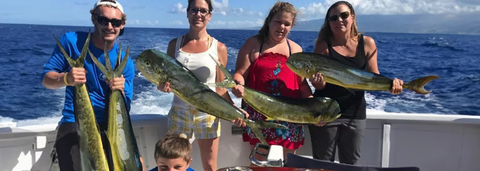 Family holding mahi mahi