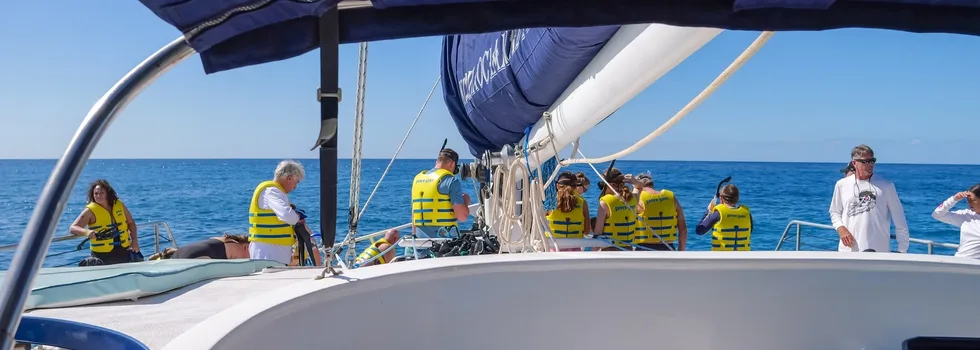 Snorkelers with life jackets koolina catamaran
