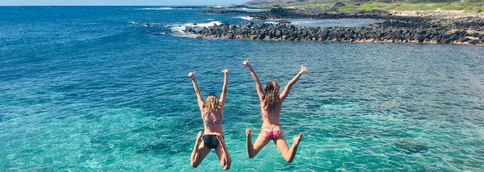 Girls jumping into water kokohead background
