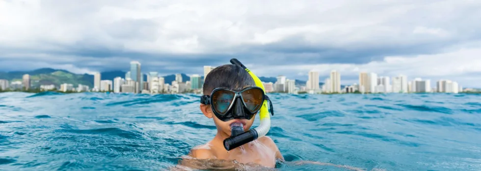 Kid snorkeling off waikiki luxury charter