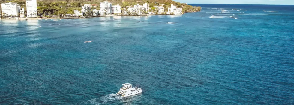 Luxury boat charter approaches diamond head