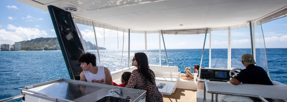 Family cruises in cockpit cabin on waikiki boat