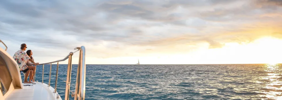 Couple watches sunset off luxury waikiki boat