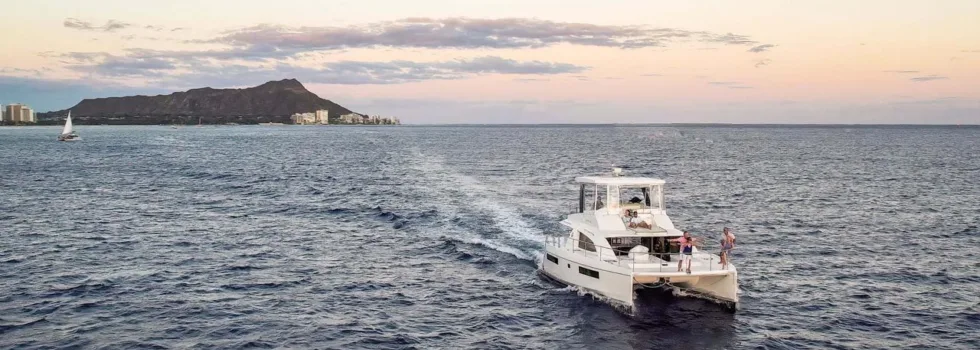 Luxury boat motoring diamond head sunset