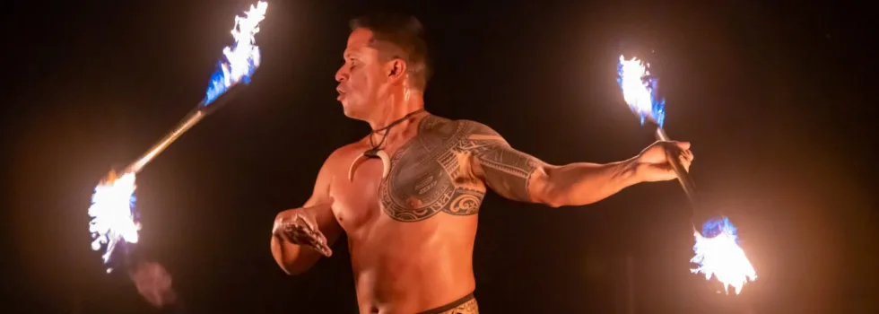 Man spins fire at casual luau maui