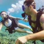 Young couple scuba maui honeymoon