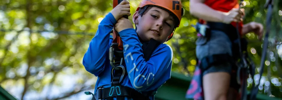 Child zipline boy launches from platform