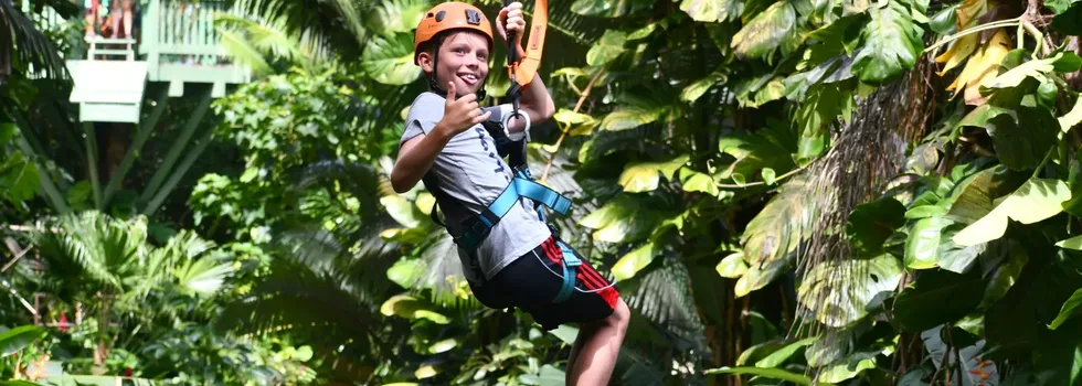 Little boy zipline guest throws shaka