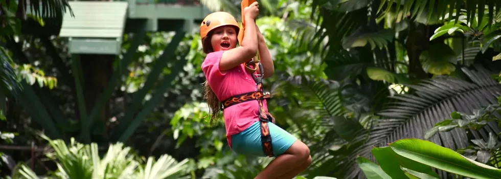 Little girl laughing while ziplining