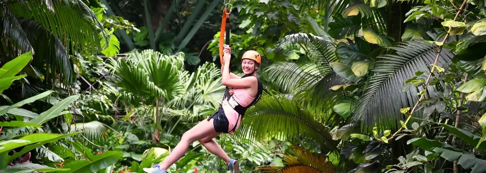 Woman smiles while ziplining on maui