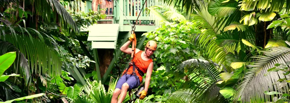 Zipline guide casually flying in haiku maui