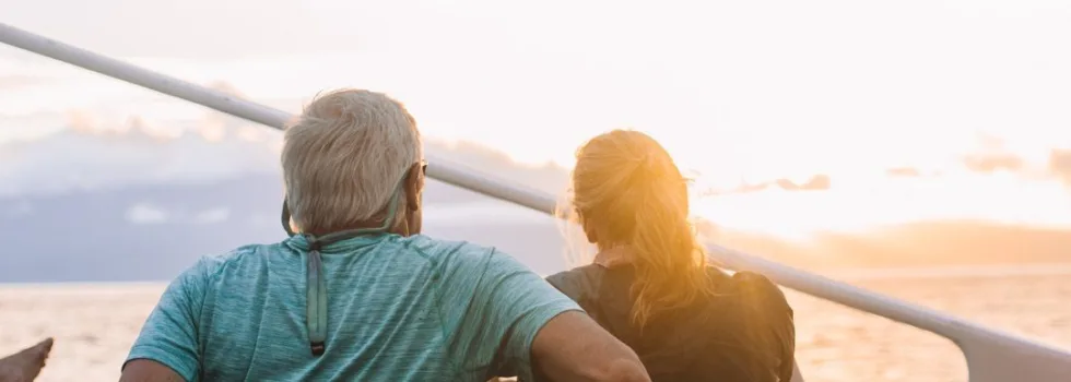 Couple watching lahaina sunset from deck of catamaran