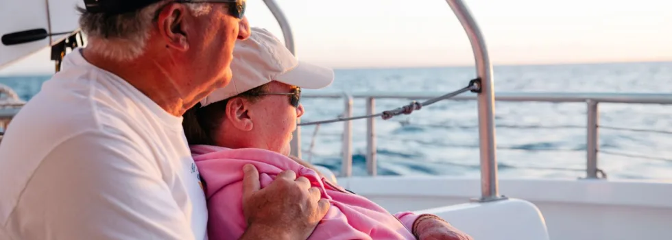 Cuddling couple lahaina sunset catamaran