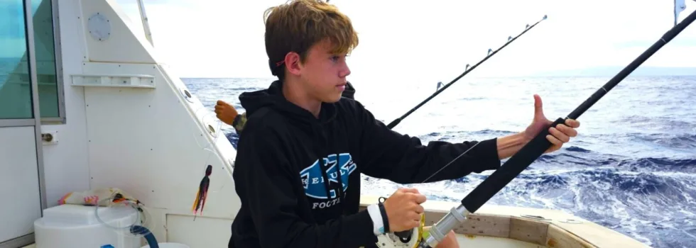 Teenage boy deep sea fishing