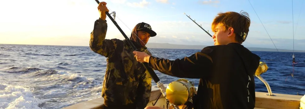 Teenage boy learning to deep sea fish
