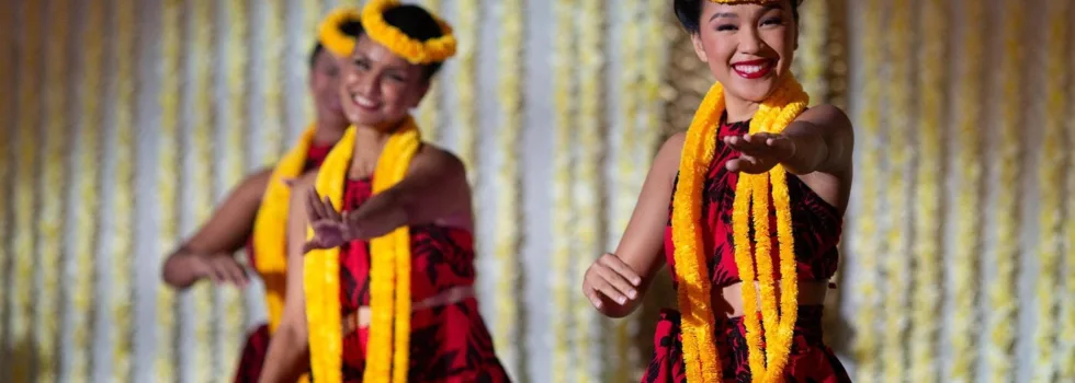 Hula dancers in red gowns