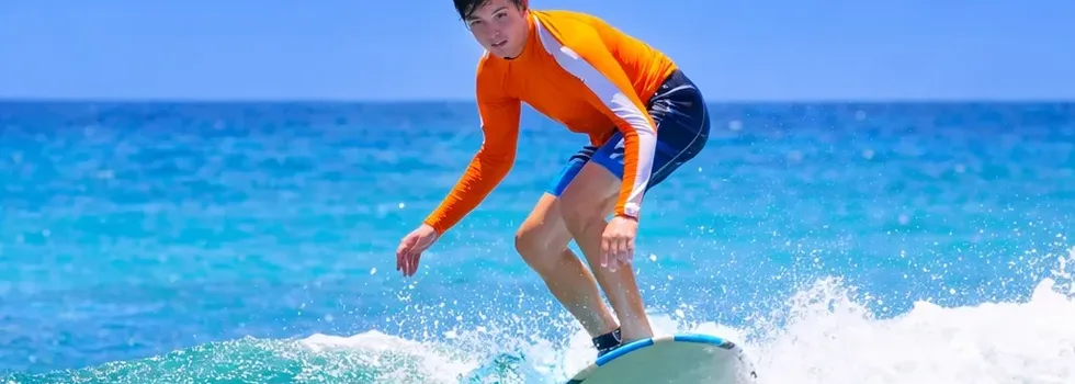 First time surfer rides a wave