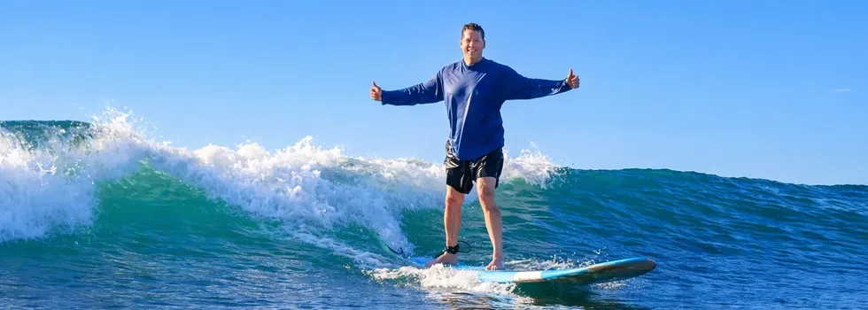 Happy big man surfing